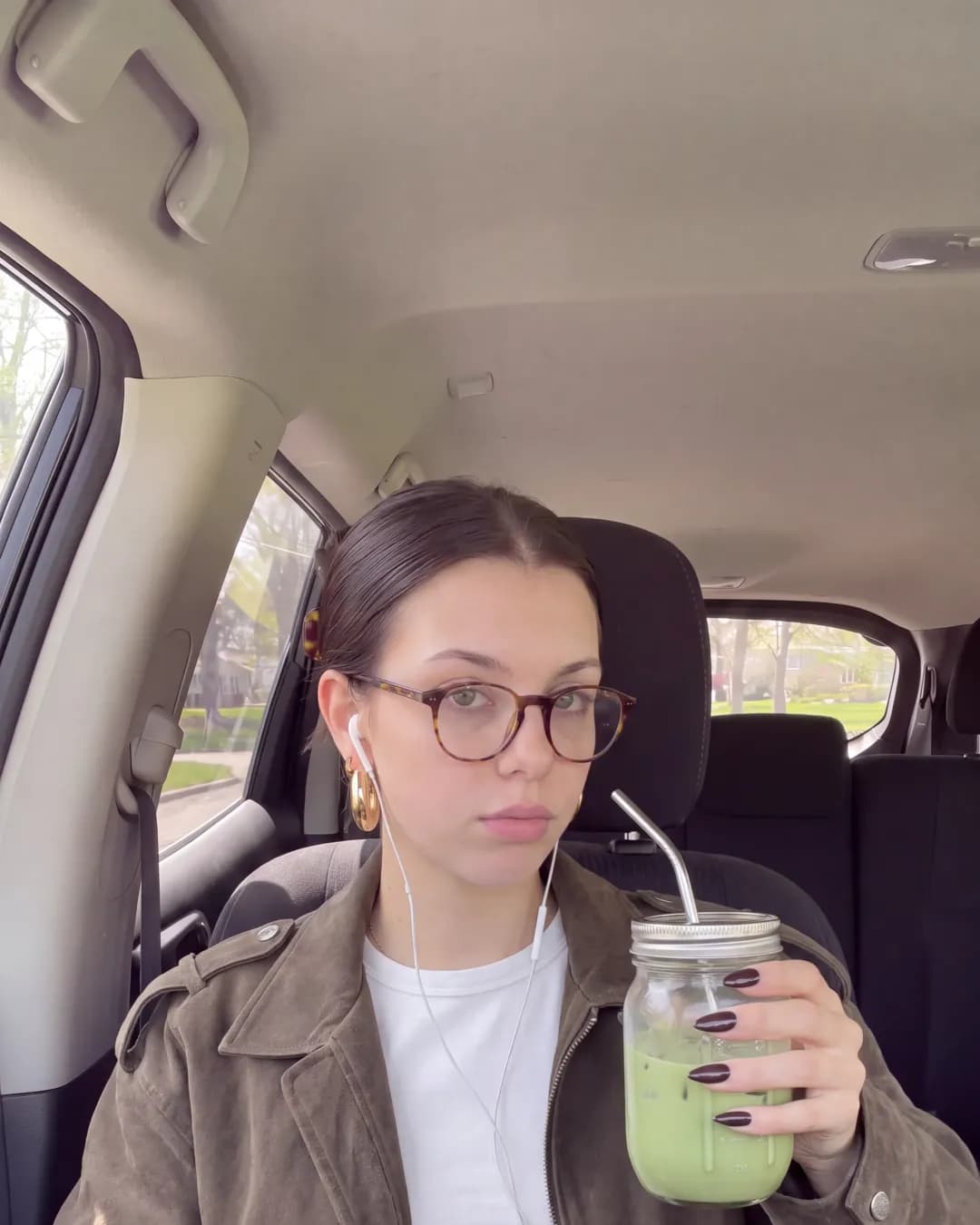 Katherine in the car, brown jacket
