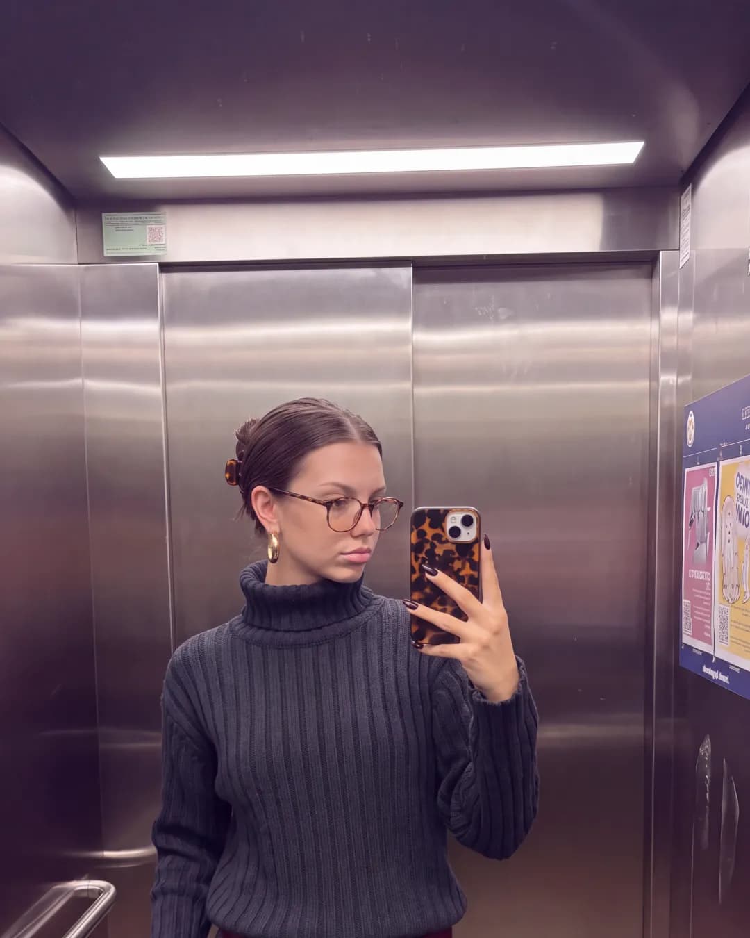 Katherine taking an elevator mirror selfie