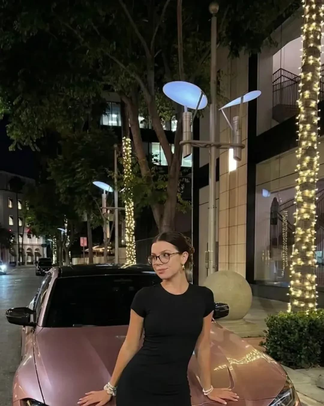 Freya next to a car at night