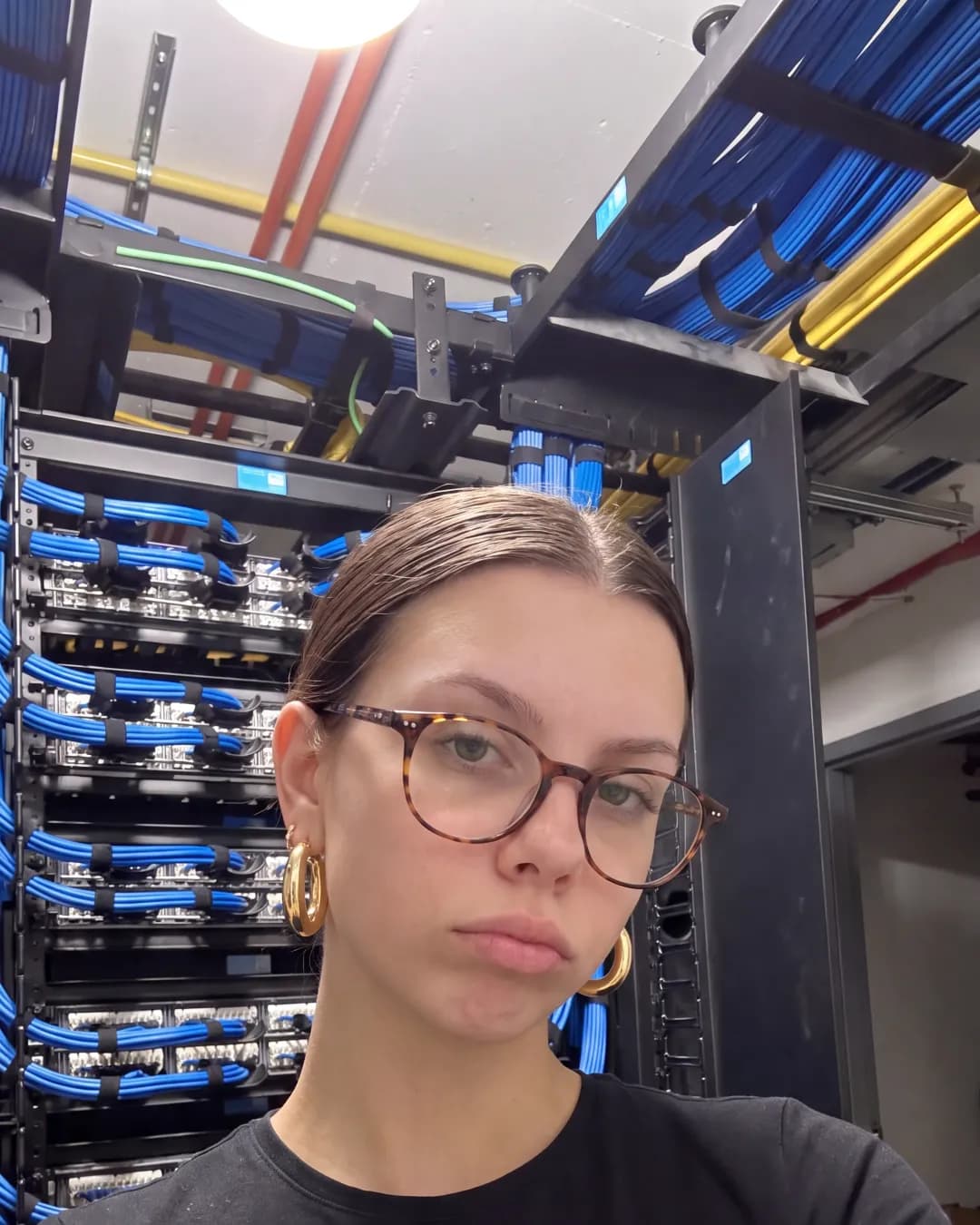 Katherine taking a selfie in a server room